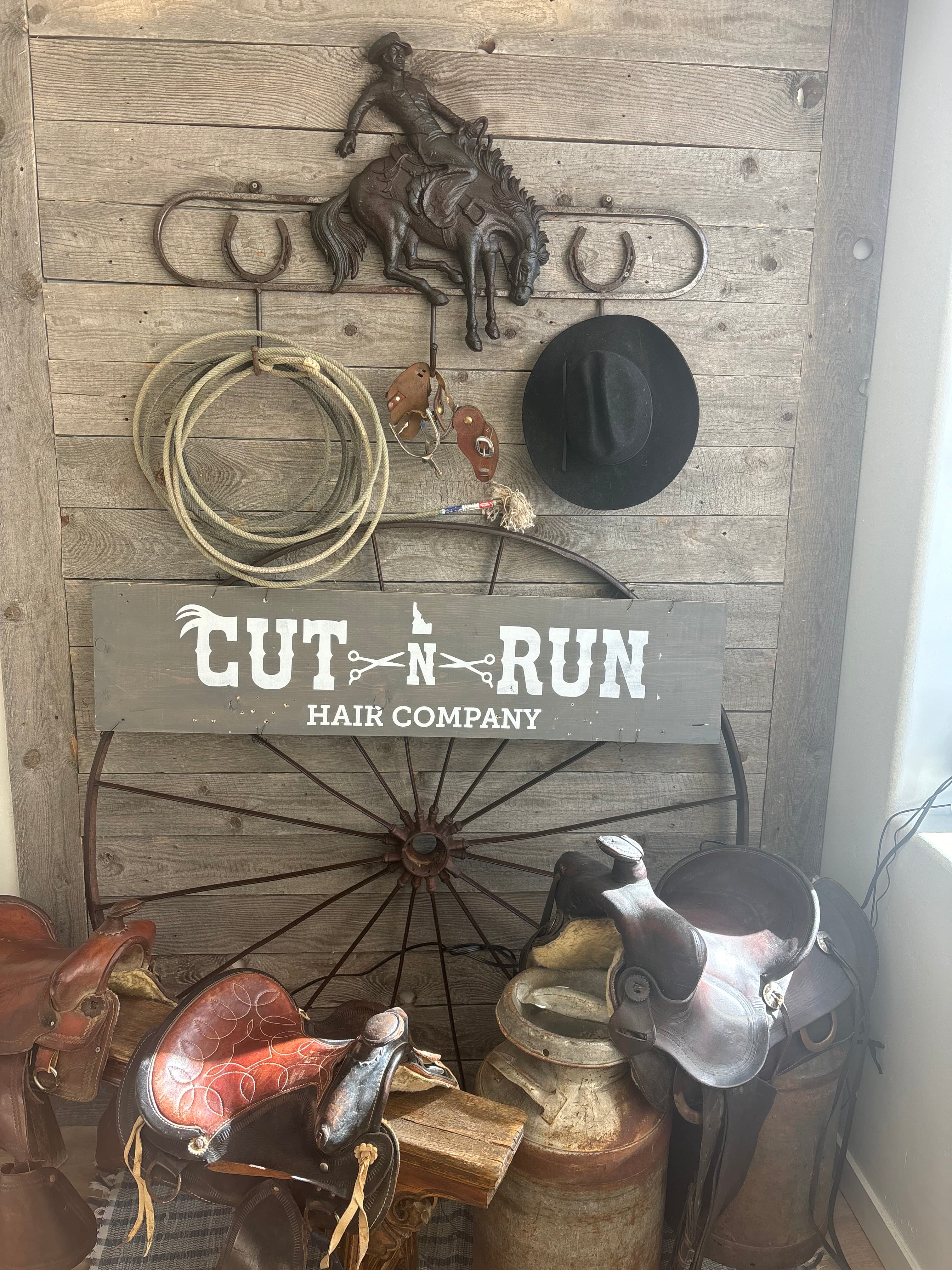 Saddles, wagon wheel, and the Cut N Run sign